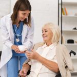 nurse-giving-tea-old-woman (1)